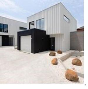 a house with some rocks in front of it at Timor Street Apartments in Warrnambool