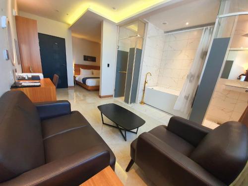 a living room with a couch and a bedroom at Benikea Hotel Yangsan in Yangsan