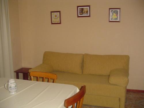 a living room with a couch and a table at Apart da Cachoeira in Florianópolis