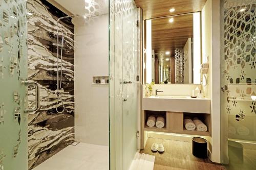 a bathroom with a shower and a sink at Wyndham Garden Kuta Beach Bali in Kuta