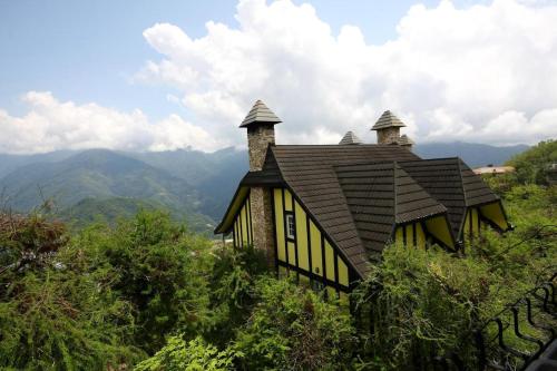 a small house on top of a mountain at Provence Rose Lodge in Renai