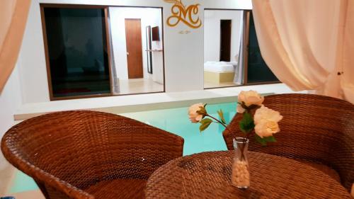 a table with two chairs and a vase with flowers at Montecarlo Villas Panglao in Panglao