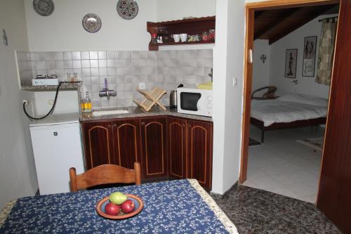 a kitchen with a table with a plate of fruit on it at Switzerland In Amirim in Amirim