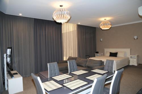 a living room with a couch and a table and a bed at Wentworth Grande Resort in Wentworth