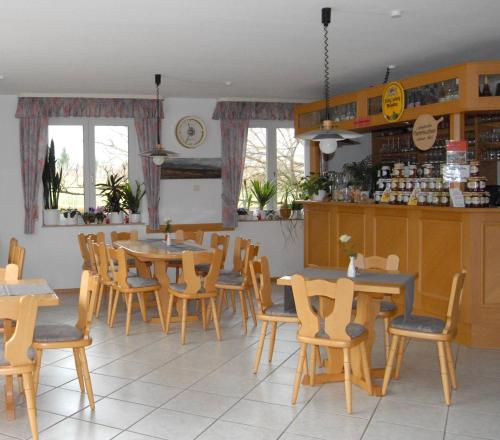 ein Restaurant mit Tischen und Stühlen in einem Zimmer in der Unterkunft Gästehaus Kleine Kalmit in Landau in der Pfalz