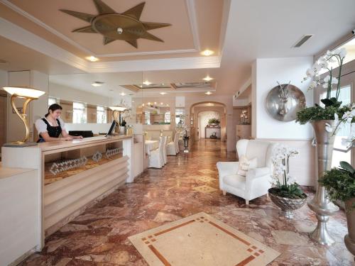 a woman standing at a counter in a salon at Rumer Hof in Innsbruck