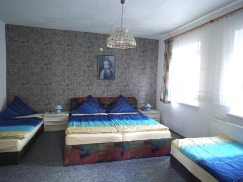 布賴騰布倫的住宿－Ferienwohnung Neubert，一间卧室配有两张单人床和吊灯。