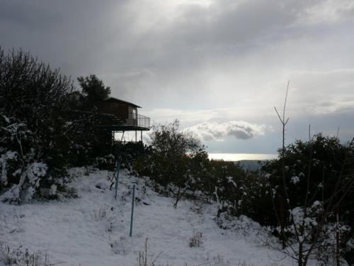 a house on top of a snow covered hill at Switzerland In Amirim in Amirim