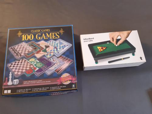 a game of games is shown next to a book at Apartment in Old Town - view of Mariacki Church in Gdańsk