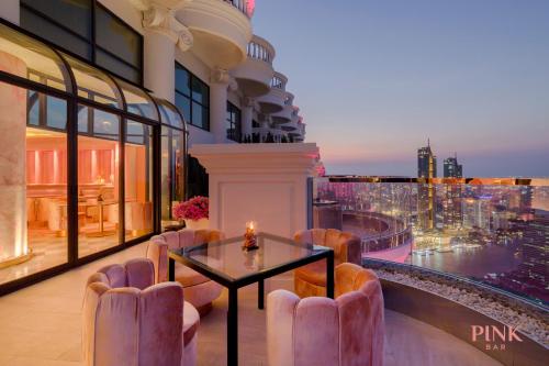 a restaurant on the top of a building with a table and chairs at Tower Club at lebua in Bangkok