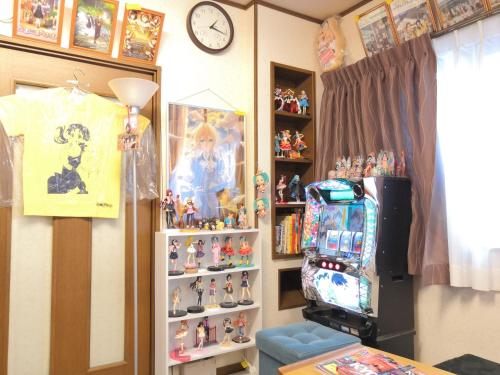a room with a video game machine and toys at Tiny GuestHouse Umekoji 梅小路 in Kyoto