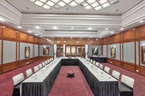 a conference room with long tables and chairs at Club Mahindra White Meadows Manali in Nagar