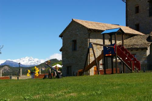 a childrens playground with a slide and a slideintend at Casas Pirineo, Ainsa in Aínsa