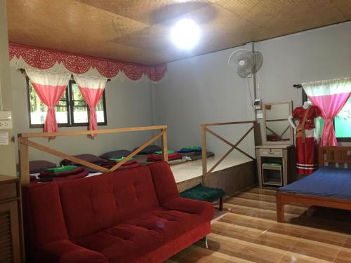 a living room with a couch and a bed at Thong Family Homestay Chiangdao in Chiang Dao
