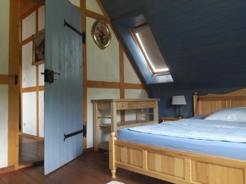 a bedroom with a bed and a blue ceiling at Ferienhaus Brotenfeld in Brotenfeld