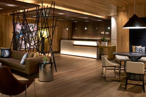 a lobby with a couch and a table and chairs at Kimpton Hotel Palomar Los Angeles Beverly Hills by IHG in Los Angeles