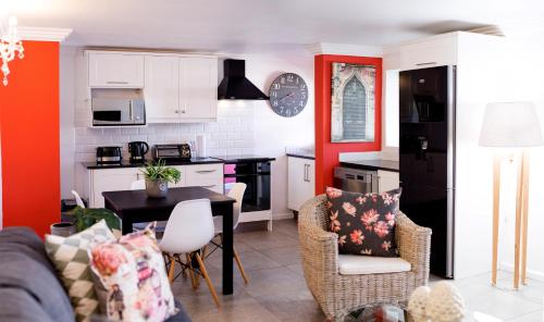 a kitchen and living room with a table and chairs at 1926 Self Catering in Piketberg