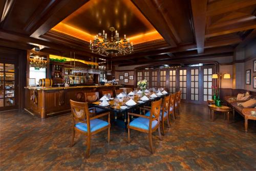 a dining room with a long table and chairs at Rocks Hotel in Macau