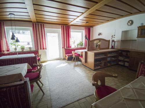 a living room with red chairs and a table at Gästehaus Panorama in Biberwier