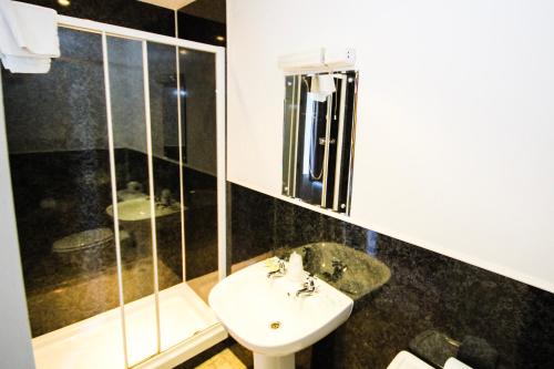 a bathroom with a sink and a shower at The Kings Arms in Shap