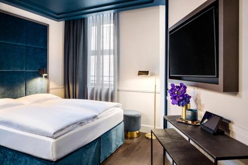 Postel nebo postele na pokoji v ubytování Hotel AMO by AMANO Friedrichstraße