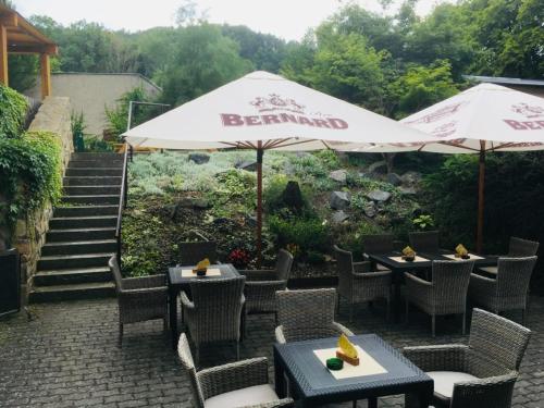 a restaurant with tables and chairs and an umbrella at Penzion Nové Odry in Odry