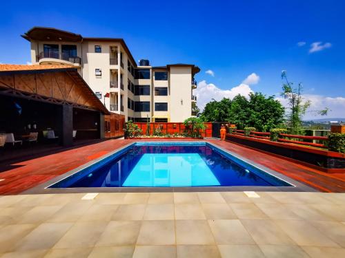 a swimming pool in front of a building at Peponi Living Spaces in Kigali