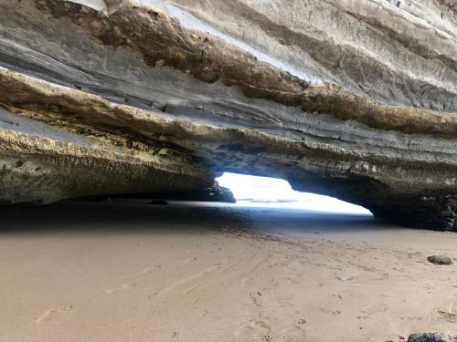 an entrance to a cave on the beach at Surf & Skate in Taghazout