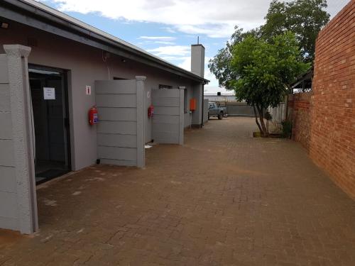 a row of garage stalls in a brick building at A’ La Maison Guesthouse in Kimberley