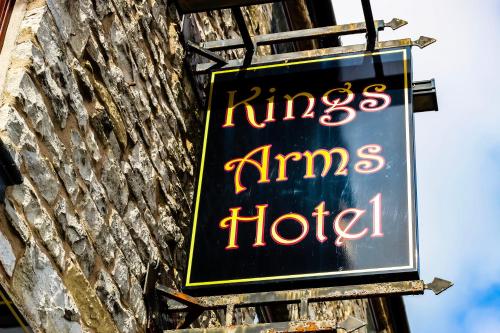 a sign for a kings arms hotel on a brick building at The Kings Arms in Shap