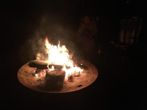 a fire pit in a dark room with flames at Ferienwohnung Kastanienblick oder Parkblick, oder unser Radlerzimmer! in Ziethen