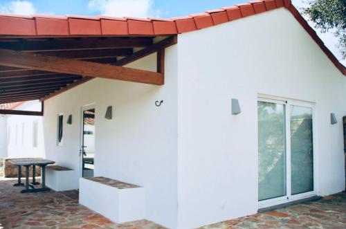 a white house with a red roof at Casa do Sobreiro-Quinta do Briando in Portalegre
