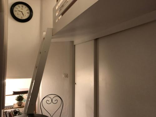 a sliding door with a clock on the wall at Studio Vieux Lyon in Lyon