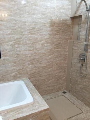 a bathroom with a sink and a shower at Peters Villa in Ban Nakhon Chum