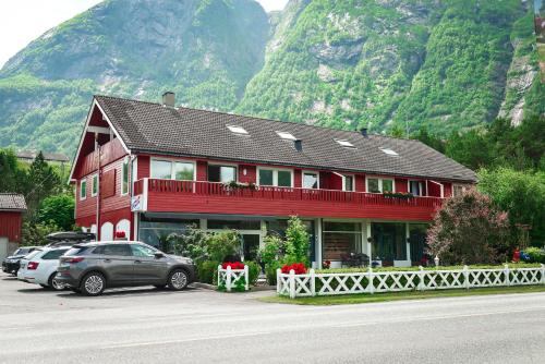 a red building with cars parked in front of it at Ingrids Apartments in Eidfjord
