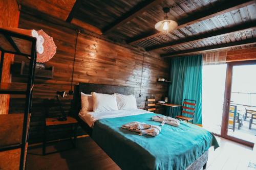 a bedroom with a bed with towels on it at Wooden Hotel Kazbegi in Kazbegi