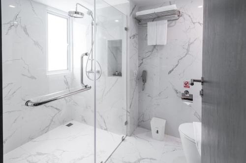 a bathroom with a glass shower with a toilet at S Ram Leisure Hotel SHA PLUS in Bangkok