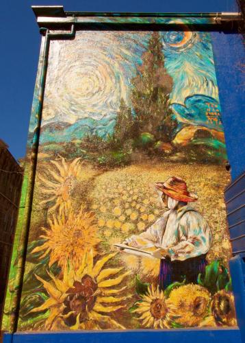 a painting of a man in a field of sunflowers at Casa California Guesthouse in Valparaíso