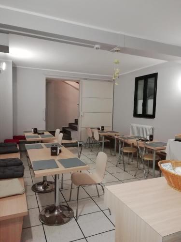 a classroom with tables and chairs and a chalkboard at Miu Hotel in Milan