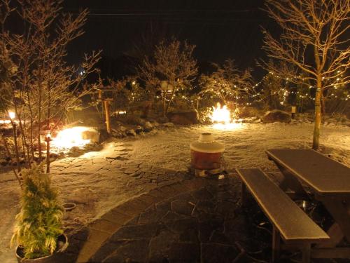 a fire hydrant sitting next to a bench at night at Shinshu Wakaho Gibier B&B in Nagano