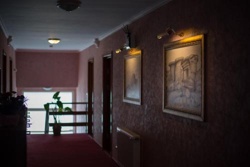 a hallway with paintings on the walls of a building at Hotel Marea Neagra in Sinaia