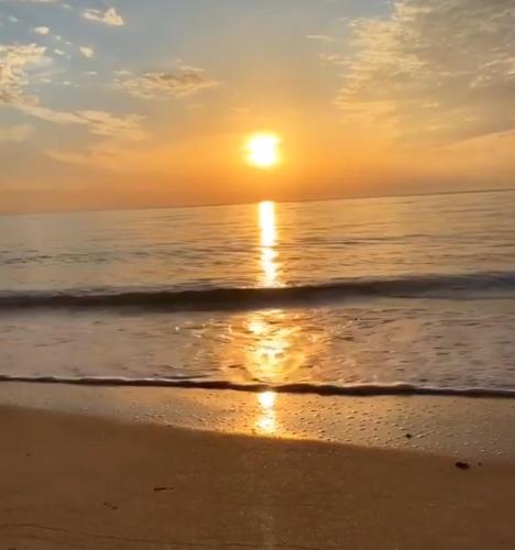 a sunset on a beach with the ocean at Chuiba Bay lodge in Pemba