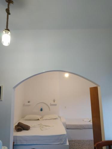 a bedroom with a bed with an archway at stamatia's rooms in Agios Kirykos
