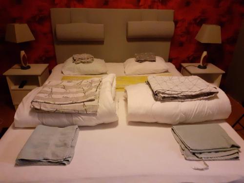 two beds in a room with white sheets and towels at Holiday Home Byvägen 38 in Nattavaara