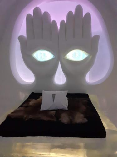 a room with a bed with eyes projected on it at Holiday Home Byvägen 38 in Nattavaara