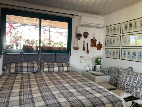 sypialnia z łóżkiem, oknem i umywalką w obiekcie Terrazza Pavone w mieście Aci Castello