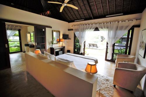 a bedroom with a bed and chairs in a room at Chuiba Bay lodge in Pemba