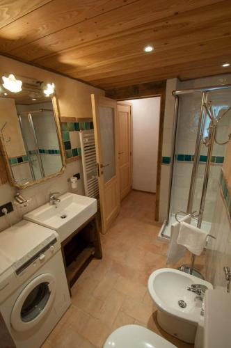 a bathroom with a sink and a toilet and a shower at La Cascina d'Orleans in Saint-Pierre