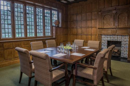 a dining room with a wooden table and chairs at Wotton House in Dorking