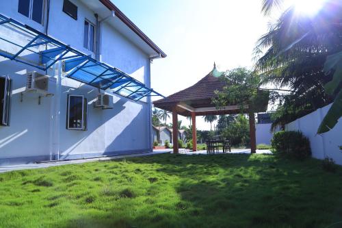 a courtyard of a house with a gazebo at PJ Hotels Jaffna in Jaffna